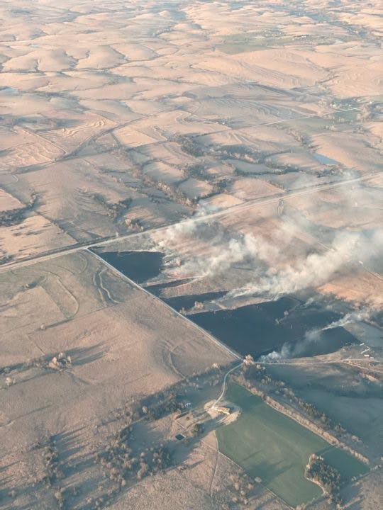 Flight over coordinated burn - view of burning field